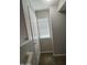 Hallway featuring a window with blinds, neutral wall paint, and a white door at 2402 E 5Th St # 1428, Tempe, AZ 85288