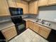 Functional kitchen with stainless steel appliances, light wood cabinets, and durable countertops at 2402 E 5Th St # 1428, Tempe, AZ 85288
