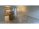 Open-concept living space featuring tile flooring, a kitchen island, and neutral wall paint at 2402 E 5Th St # 1428, Tempe, AZ 85288