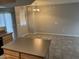 Spacious kitchen with island and adjacent area, featuring tile flooring, pendant lighting and neutral walls at 2402 E 5Th St # 1428, Tempe, AZ 85288