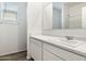 Bathroom features a single sink vanity with a large mirror and a shower over bath at 25207 N 183Rd Dr, Wittmann, AZ 85361