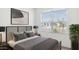 Serene bedroom featuring neutral colors, a patterned headboard, and a large window overlooking the street at 25207 N 183Rd Dr, Wittmann, AZ 85361