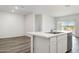 Modern kitchen with white cabinets, stainless steel dishwasher, and a spacious island with a sink at 25207 N 183Rd Dr, Wittmann, AZ 85361
