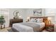 Relaxing main bedroom features a wooden bed frame, bedside tables, and modern decor accents at 25207 N 183Rd Dr, Wittmann, AZ 85361