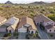 Property aerial showcasing desert landscape, mountain views, and well-maintained homes with solar panels at 26743 N 65Th Dr, Phoenix, AZ 85083