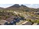Scenic aerial view of a desert community with stunning mountain views and well-maintained streets at 26743 N 65Th Dr, Phoenix, AZ 85083