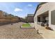 Spacious backyard with gravel, concrete, patio, and seating area, perfect for outdoor living at 26743 N 65Th Dr, Phoenix, AZ 85083