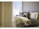 Comfortable bedroom featuring a cozy bed with decorative pillows, soft lighting, and neutral tones at 26743 N 65Th Dr, Phoenix, AZ 85083