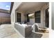 Relaxing covered patio with comfortable seating, a mounted TV, and outdoor lighting for entertainment at 26743 N 65Th Dr, Phoenix, AZ 85083