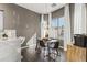 A modern dining area showcases a glass table, stylish chairs, pendant lighting and lots of natural light at 26743 N 65Th Dr, Phoenix, AZ 85083