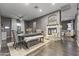 Open-concept dining room with a cozy stone fireplace and comfortable seating at 26743 N 65Th Dr, Phoenix, AZ 85083