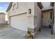 Inviting home exterior featuring stone accents, well-lit entrance, and tidy desert landscaping at 26743 N 65Th Dr, Phoenix, AZ 85083