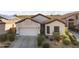 Charming single-story home featuring a well-manicured yard, desert landscaping, and a two-car garage at 26743 N 65Th Dr, Phoenix, AZ 85083