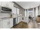 Well-lit kitchen with stainless steel appliances, white cabinetry, and marble countertops at 26743 N 65Th Dr, Phoenix, AZ 85083