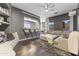 Stylish living room featuring a comfortable sectional sofa, bar seating, and a cozy fireplace at 26743 N 65Th Dr, Phoenix, AZ 85083
