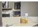 Built-in shelving with stylish decor and ambient lighting above a beautifully accented stone fireplace at 26743 N 65Th Dr, Phoenix, AZ 85083