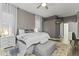 A cozy main bedroom displays a plush bed, neutral colors, ceiling fan and soft natural lighting at 26743 N 65Th Dr, Phoenix, AZ 85083