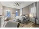 Comfortable main bedroom features a ceiling fan, accent rug, neutral colors and natural light at 26743 N 65Th Dr, Phoenix, AZ 85083