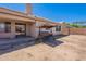Expansive backyard view displaying a swing, patio, and perimeter block fencing at 2714 E Valencia Dr, Phoenix, AZ 85042