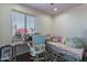 A cozy bedroom and study featuring a bright window at 2714 E Valencia Dr, Phoenix, AZ 85042