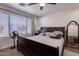 Comfortable bedroom featuring a ceiling fan and large window at 2714 E Valencia Dr, Phoenix, AZ 85042