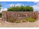 Stone community sign for 'The Groves at South Mountain' with colorful desert landscaping and bright blue sky at 2714 E Valencia Dr, Phoenix, AZ 85042