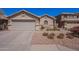 Charming single-story home featuring a two-car garage and desert landscaping at 2714 E Valencia Dr, Phoenix, AZ 85042