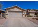 Single-story home featuring desert landscaping and a spacious driveway at 2714 E Valencia Dr, Phoenix, AZ 85042