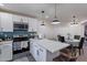 Open concept kitchen with an island and a breakfast nook with a table at 2714 E Valencia Dr, Phoenix, AZ 85042