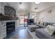 Cozy living room with a fireplace and patio access at 2714 E Valencia Dr, Phoenix, AZ 85042