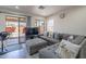 Comfortable living room featuring a plush sectional and sliding glass doors to the backyard at 2714 E Valencia Dr, Phoenix, AZ 85042