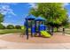 Community playground with blue and green play structure in a park-like setting with mature trees at 2714 E Valencia Dr, Phoenix, AZ 85042
