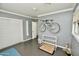 A room with a bike, bed, cat accessories, and storage, painted with light grey walls and white trim at 3015 E Sells Dr, Phoenix, AZ 85016