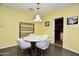 Modern dining area with round marble table, pendant lighting and white chairs at 3015 E Sells Dr, Phoenix, AZ 85016