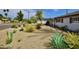 Landscaped front yard featuring desert plants, gravel, and shrubbery, adding curb appeal to the property at 3015 E Sells Dr, Phoenix, AZ 85016