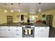Spacious kitchen with stone countertops, modern appliances, pendant lighting, and open layout to the living area at 3015 E Sells Dr, Phoenix, AZ 85016