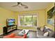 Bright living room with ceiling fan, a backyard view, and tile floors at 3015 E Sells Dr, Phoenix, AZ 85016