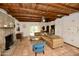 Spacious living room with stone fireplace, wood-beamed ceiling, and ample seating at 3015 E Sells Dr, Phoenix, AZ 85016
