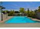 Private in-ground pool with basketball hoop surrounded by lush landscaping at 3015 E Sells Dr, Phoenix, AZ 85016