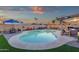 Inviting backyard with a uniquely shaped pool, covered patio with grill, and ample seating for outdoor entertainment at 3121 E Sierra St, Phoenix, AZ 85028