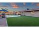 Gorgeous backyard showcasing lush turf, a sparkling pool, covered patio, and desert sunset views at 3121 E Sierra St, Phoenix, AZ 85028