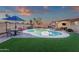 Large backyard featuring a sparkling pool, lush turf, covered patio, and dining area, ideal for outdoor living at 3121 E Sierra St, Phoenix, AZ 85028