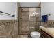 Bathroom featuring a shower with glass door, tile surround, and granite counters at 3121 E Sierra St, Phoenix, AZ 85028