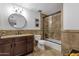 Bathroom with tile surround shower, granite counters, and dark wood vanity with storage at 3121 E Sierra St, Phoenix, AZ 85028