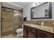 Bathroom featuring a walk-in glass shower, granite counters, and dark wood cabinets at 3121 E Sierra St, Phoenix, AZ 85028