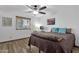 Bedroom featuring a ceiling fan, wood-look floors, and a window overlooking the front yard at 3121 E Sierra St, Phoenix, AZ 85028