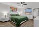 Bedroom with neutral walls and wood-look floors featuring a ceiling fan and natural light at 3121 E Sierra St, Phoenix, AZ 85028