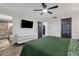 Bright bedroom featuring a sleek dresser, ceiling fan and an ensuite bathroom with a glass shower at 3121 E Sierra St, Phoenix, AZ 85028