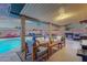 Inviting covered patio with cozy seating around the pool, plus outdoor kitchen and dining areas at 3121 E Sierra St, Phoenix, AZ 85028