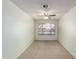 Simple room featuring carpet, ceiling fan, neutral color walls, and natural light from a window at 3140 N 114Th Dr, Avondale, AZ 85392